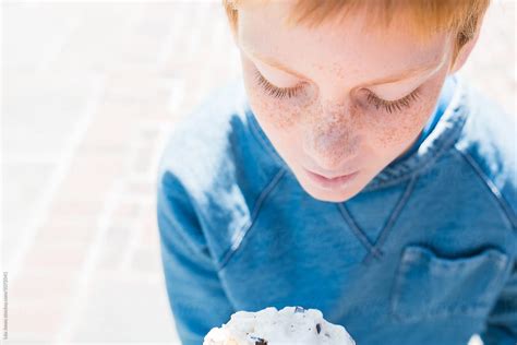 Redhead Boy With Freckles Eating Ice Cream By Stocksy Contributor