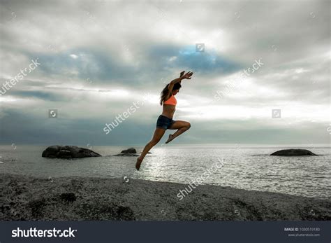 Woman Jumping On Rock Sunset On Stock Photo Shutterstock