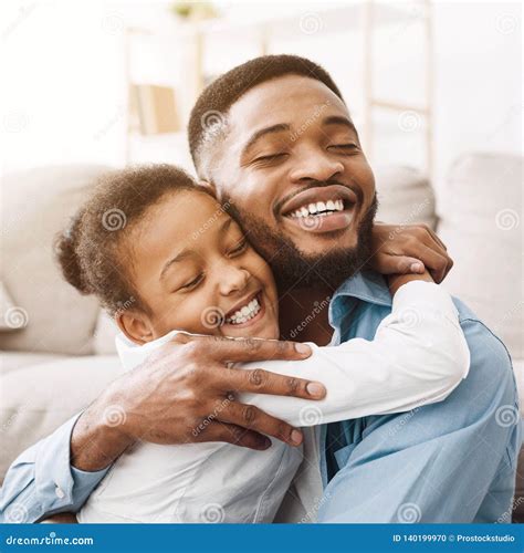 African American Daughter Hugging Father With Love Crop Stock Photo