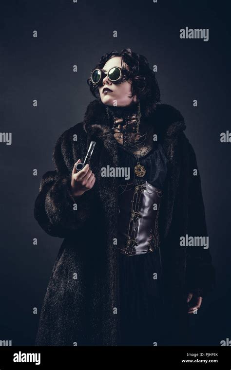 Steampunk Woman Standing Holding A Pipe Stock Photo Alamy