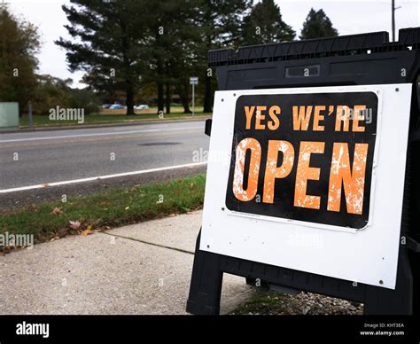 Yes Were Open Sign Placed On A Pavement Near The Road Signs To