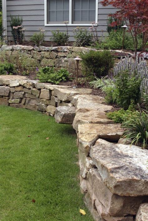 A Hand Laid Retaining Wall Made Out Of Natural Stone Two Terraces Are