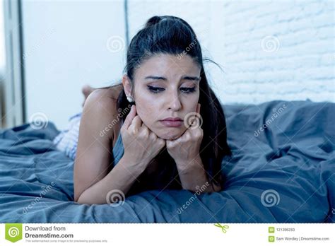 Sad And Depressed Portrait Of Latin Woman On Bed With White Back Stock Image Image Of Female