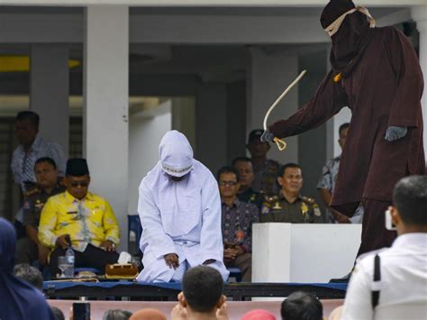 indonesia woman collapses as she s caned for ‘having sex outside marriage the courier mail