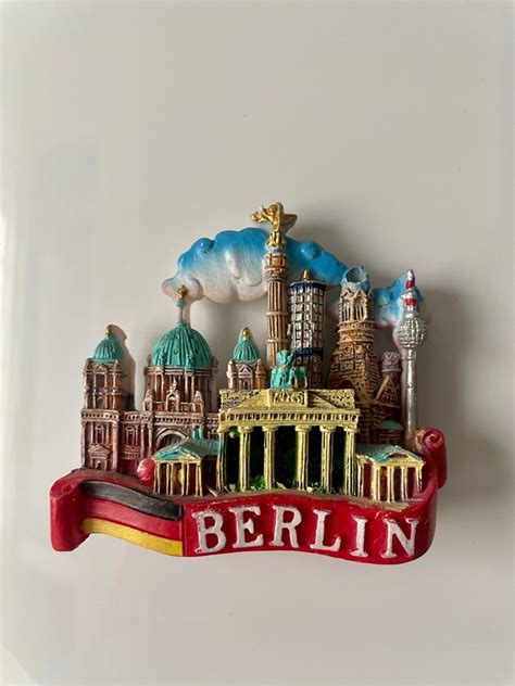 The Berlin Skyline Is Painted In Red White And Blue With An Arch That
