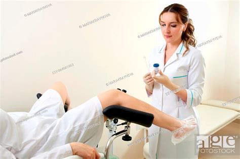 gynecologist preparing for an examination procedure for a woman sitting on a gynecological chair