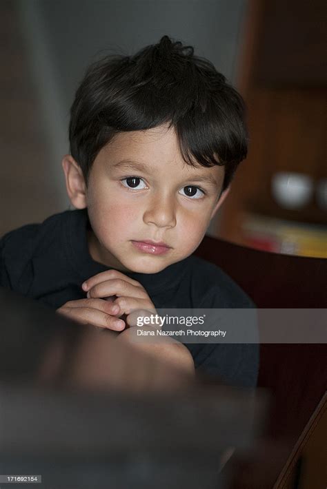 Young Boy With Dark Eyes And Dark Hair High Res Stock