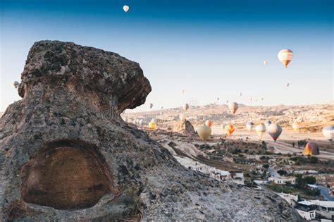 Hot Air Balloon Flying Over Rock Landscape In Cappadocia Ancient Cave
