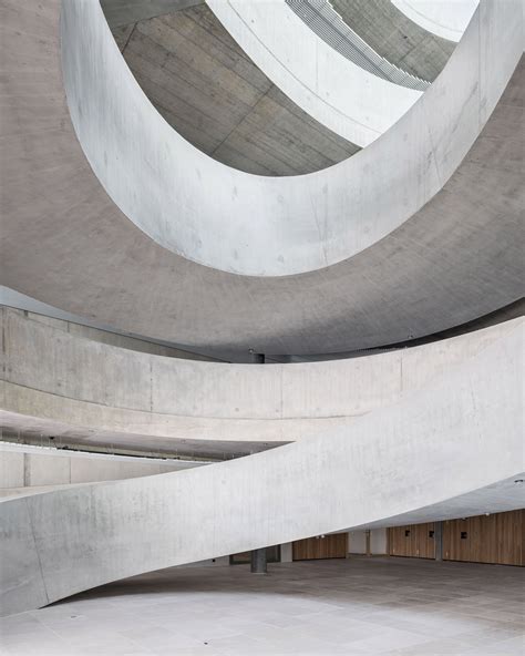 Concrete Spiral Staircase Twists Through An Open Plan Office By