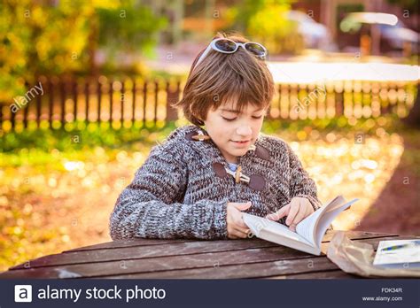 Boy Reading A Book In The Park Stock Photo Alamy