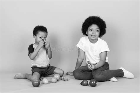 Young Cute African Siblings Together In Black And White Stock Photo