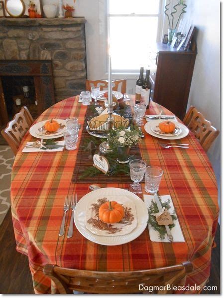 the table is set for thanksgiving dinner with plates and silverware on