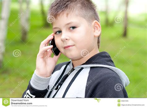 Boy Talking On Cell Phone In The Park Royalty Free Stock Photo - Image ...