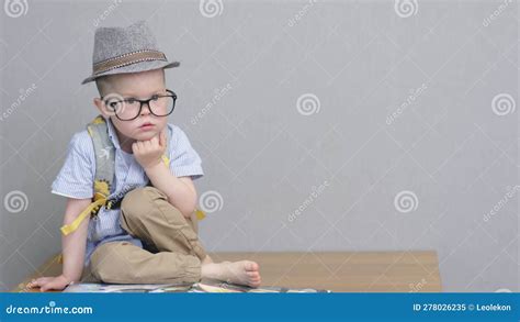 Portrait Brooding Thoughtful Preschool Boy Kid Sitting In Hat And