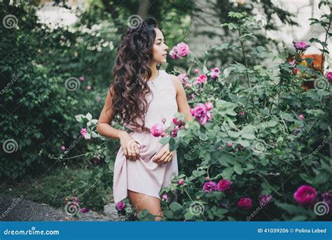 Beautiful Girl Among Pink Roses In The Garden Stock Photo Image Of