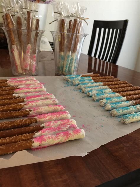 We hosted the party halfway through my pregnancy. Gender Reveal party favors- pretzel rods dipped in vanilla ...