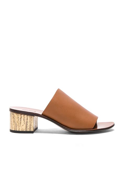 chloe qassie semi shiny calf leather mules in ochre delight fwrd