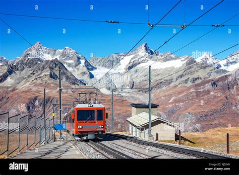 Red Tram Or Train On Rail To Matterhorn Popular Alps Peak At Zermatt