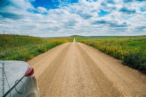 The Side Of A Car On A Long Dirt Road In Rural North Dakota With A