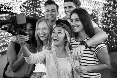 Free Photo Group Of Young Adult Friends Taking A Group Selfie With A