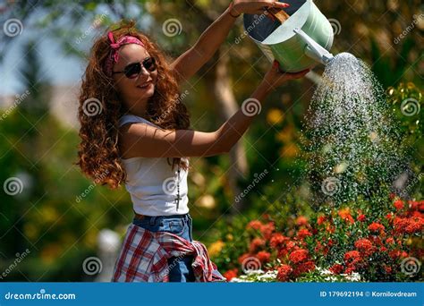 Woman In A Garden Watering Flowers Stock Photo Image Of Center