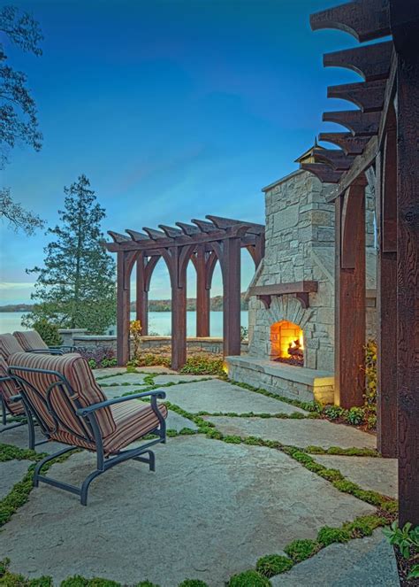 Stone Outdoor Fireplace Flanked By Rustic Pergolas Rustic Pergola