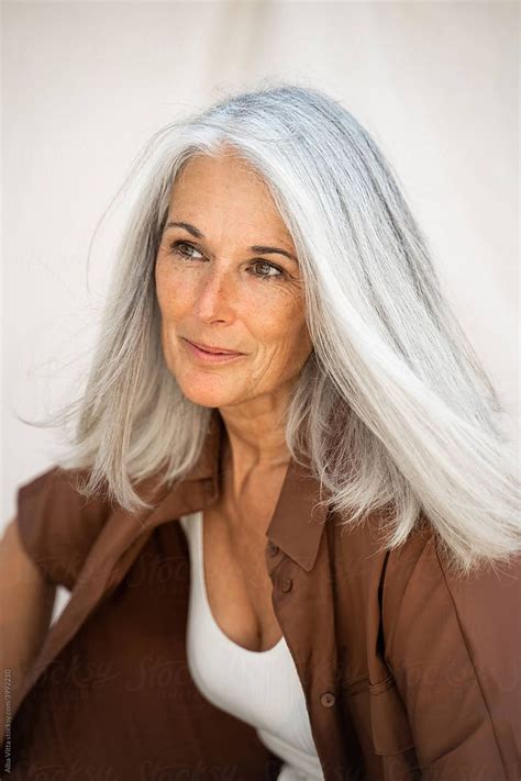 Fashion Portrait Of Beautiful Mature Woman In Front Of Sheet Backdrop