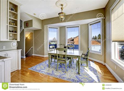 Soft, warm blue walls give this traditional dining room an elegant, romantic look. Dining Room With Green Wooden Table Set Stock Photo ...