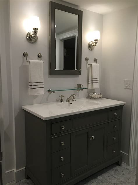 Gray tile is common and affordable, and the quartz countertop also saves money compared to marble or granite. Gray and white bathroom, marble carrera hexagon tile floor ...