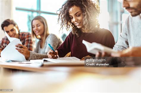 Happy Female College Student Reading A Book On A Class High Res Stock