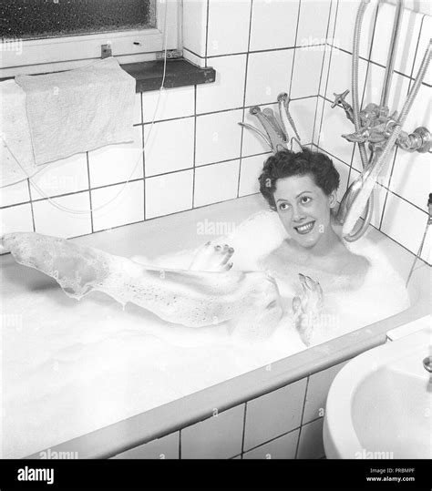 Having A Bath 1950 A Young Smiling Woman Wearing A Princess Crown Is Having A Bath In A
