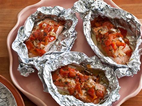Layer salmon, tomato and basil on lightly oiled foil and wrap it all up — you can even do it a night before cooking. Salmon Baked in Foil Recipe | Giada De Laurentiis | Food Network