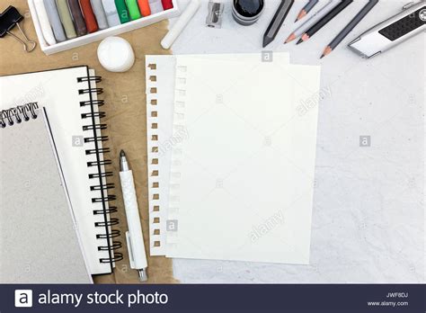 Notepad With Blank Sheet And Different Pencils With Colored Chalks On