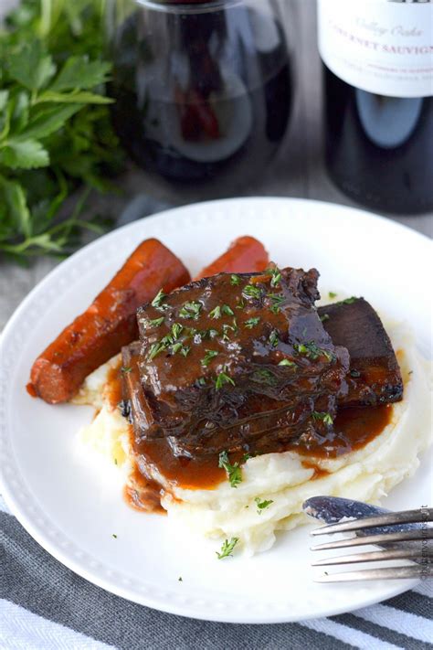 Beef Short Ribs Braised In Red Wine With Carrots On A Plate Beef Ribs