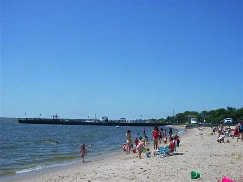 Many People Are Walking On The Beach Near The Water