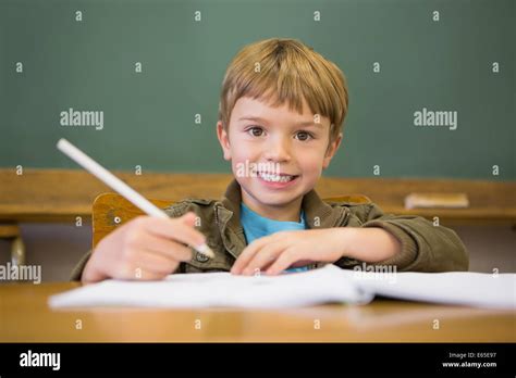 Happy Pupil Writing In Notepad At Desk Stock Photo Alamy