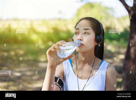 Young Sporty Woman Drinking Water In The Park Stock Photo Alamy