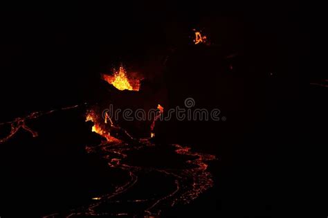 Volcanic Eruption With Glowing Orange Lava Flow Surrounded By A Pool Of