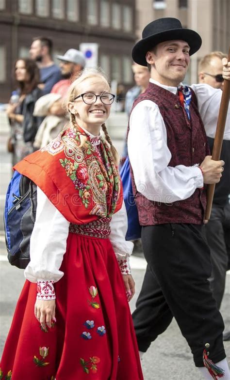 Estonian People In Traditional Clothing Walking The Streets Of Tallinn