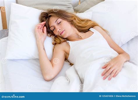 Young Beautiful Woman Sleeping In Her Bed And Relaxing Stock Photo