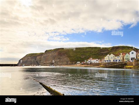 The Harbour And Seafront Cliffs Beyond In Staithes North Yorkshire