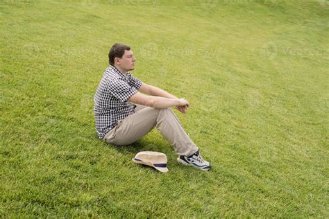 Young Thoughtful Man Sitting On The Grass In The Park 3307034 Stock