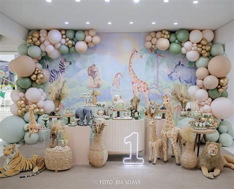 A Birthday Party With Balloons And Animals On The Wall Including Giraffes