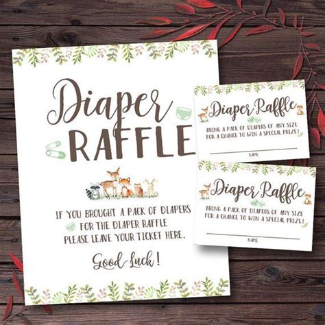 Two Diaper Raffle Coupons Sitting On Top Of A Wooden Table Next To Red