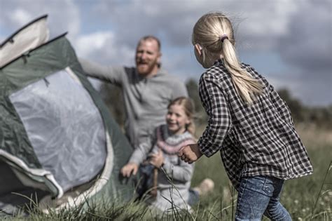 Handsome Redhead Father And Blonde Daughters Enjoying A Camping Holiday Despite The Wintry