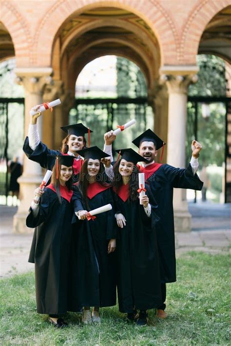 Group Of Young Graduate Students Holding Their Diploma After Graduation