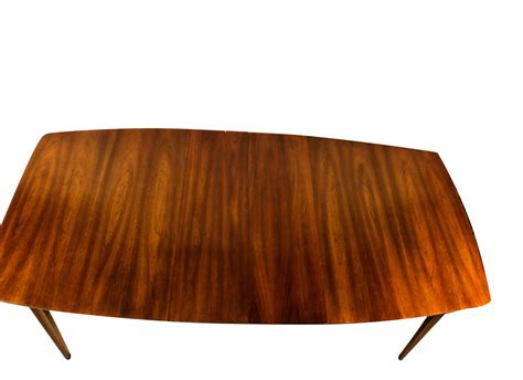 This convertible coffee table enchants with its sleek, modern appeal. Mid Century Modern Expandable Dining Table