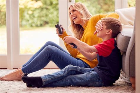 Mother And Son At Home Playing Video Game Together With Woman Cheating To Win Stock Image