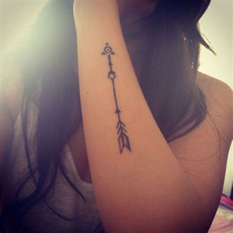 A Woman S Arm With An Arrow Tattoo On It