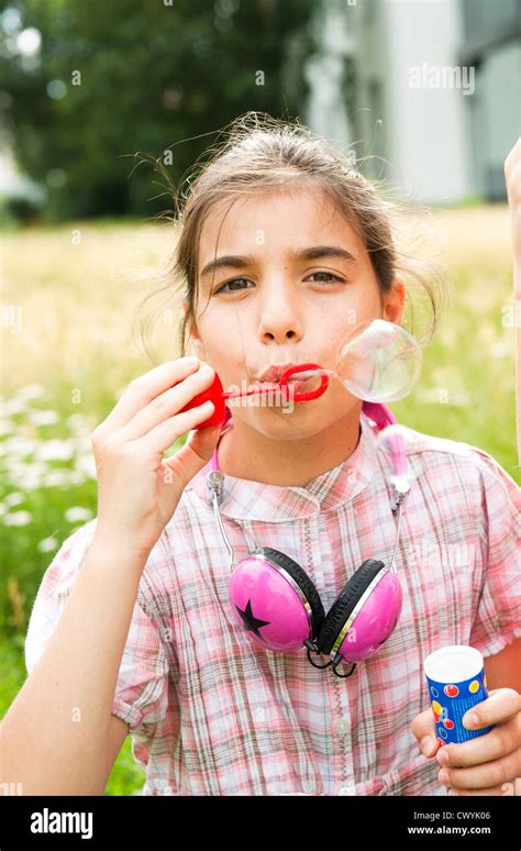 Girl Blowing Soap Bubbles Stock Photo Alamy